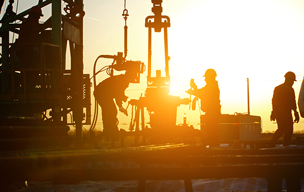 ETS CHRIS TRADING AND DRILLING PLC workers at sunset